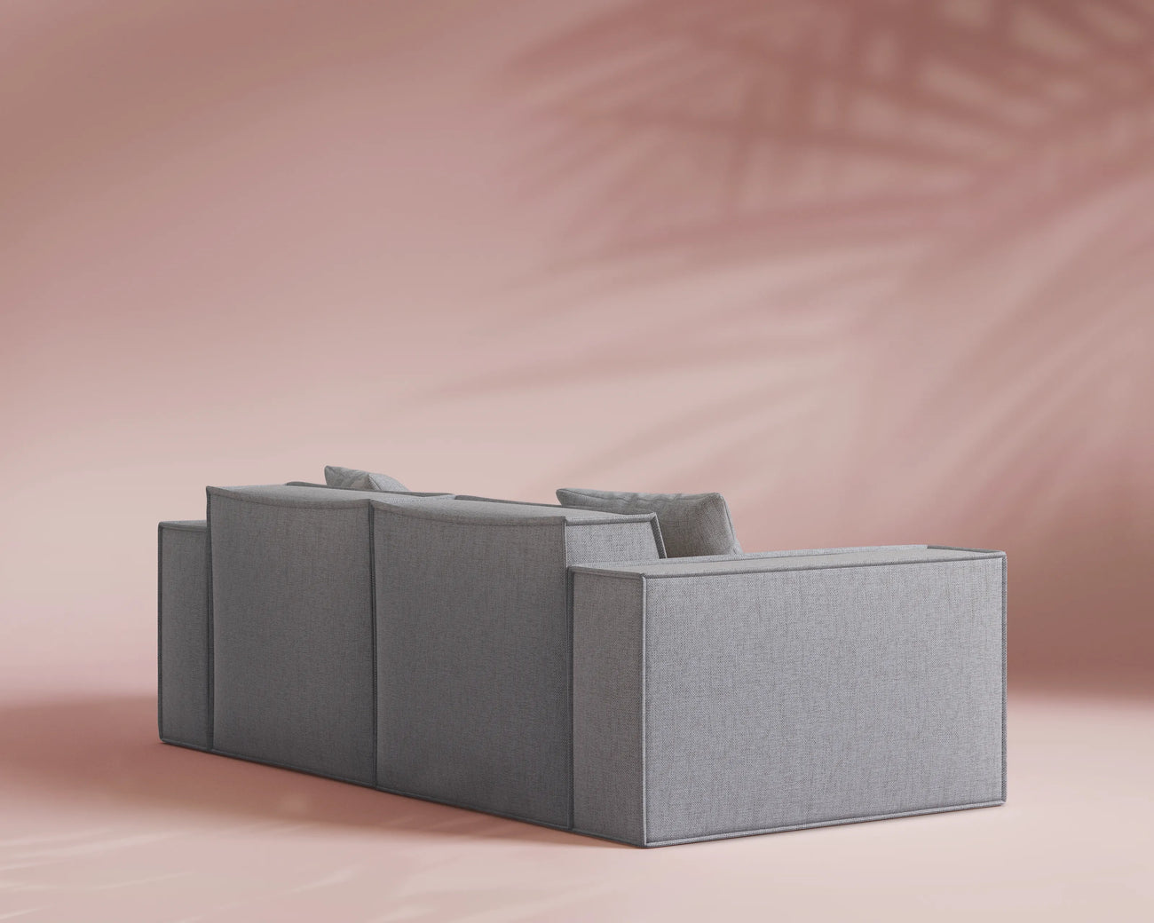 Gray sofa on a pink background