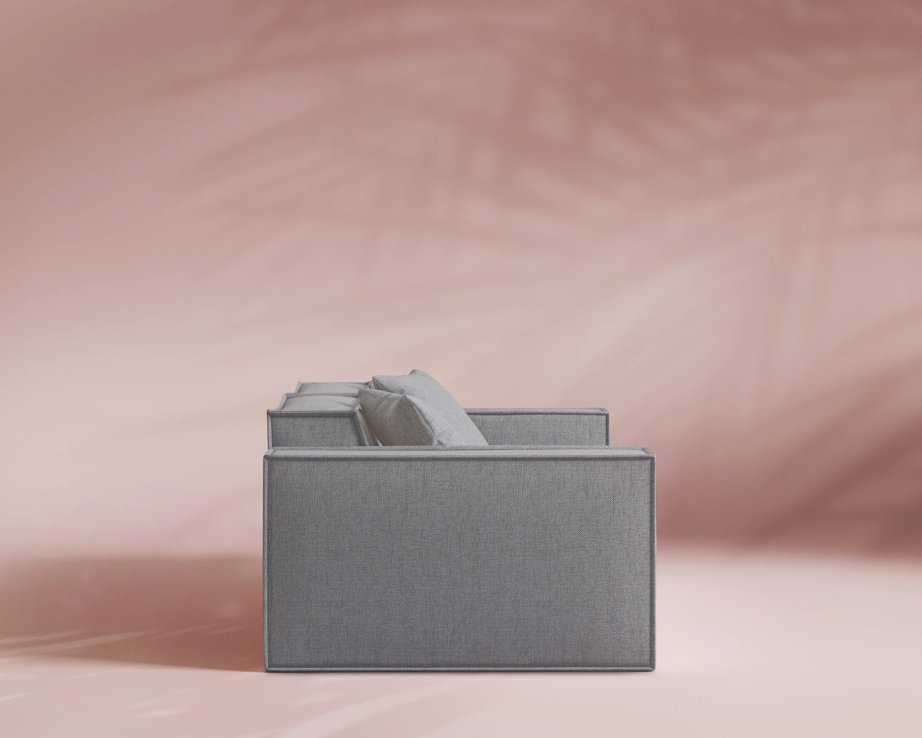 Gray sofa on a pink background