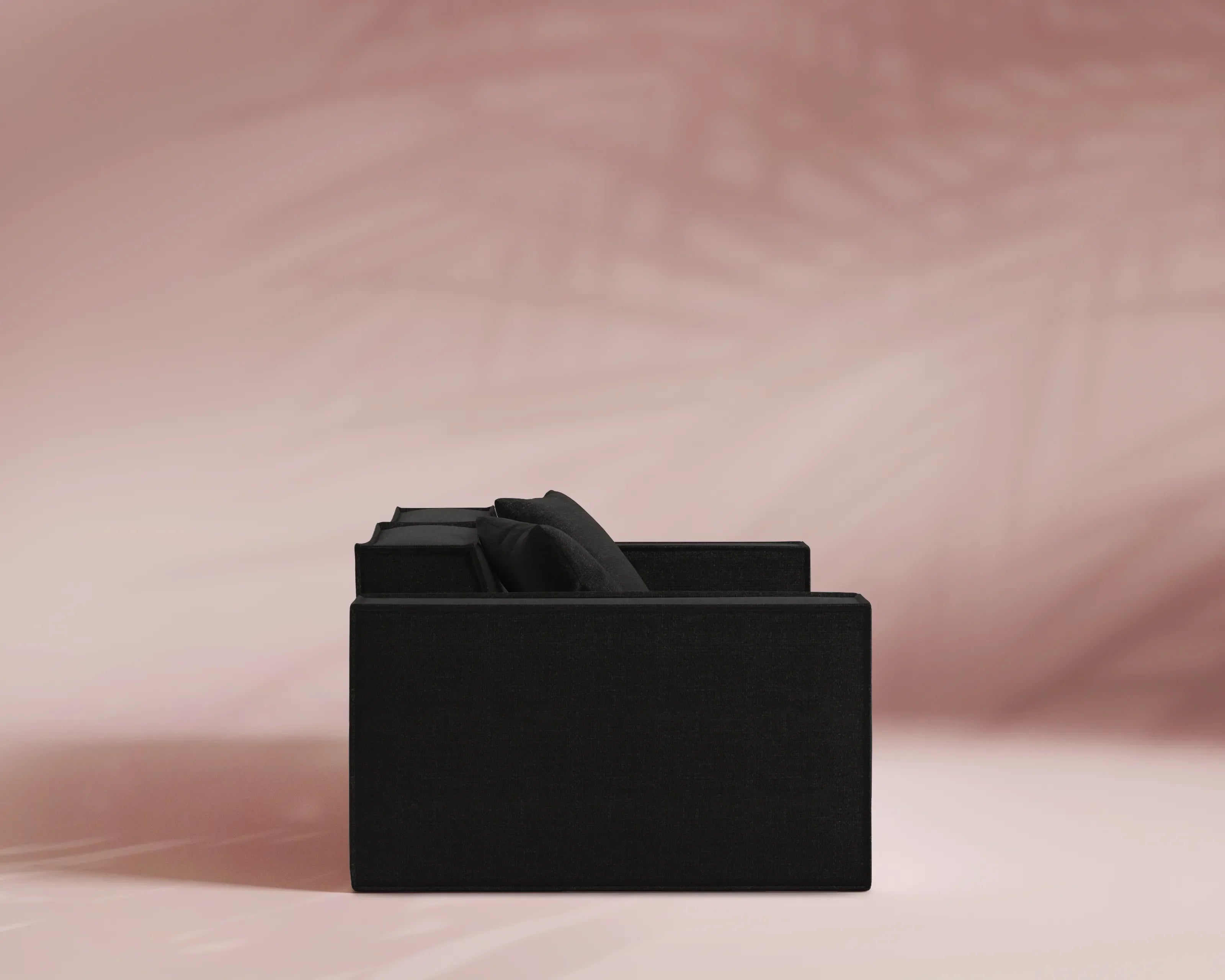 Black sofa on a pink background