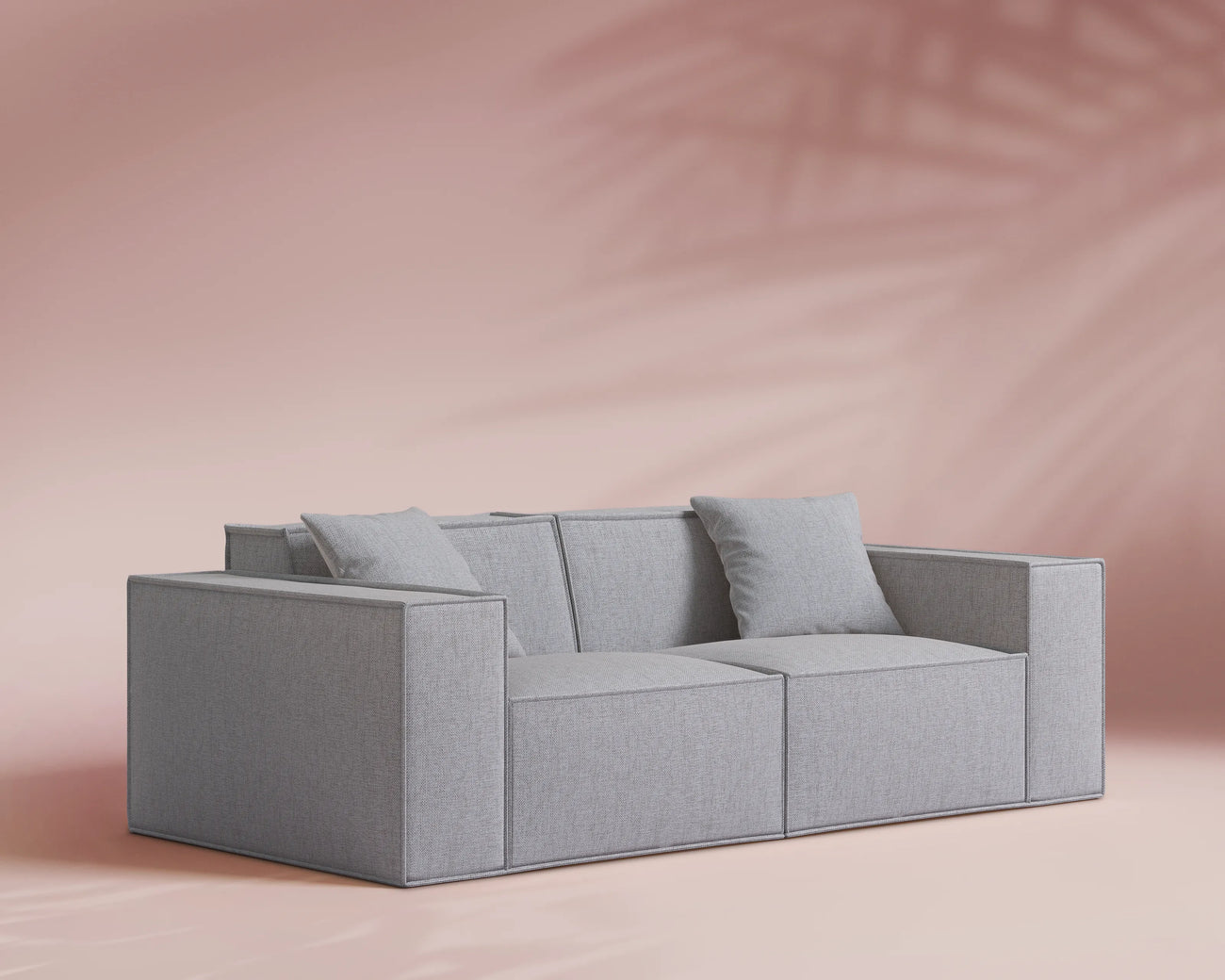 Gray sofa against a pink background