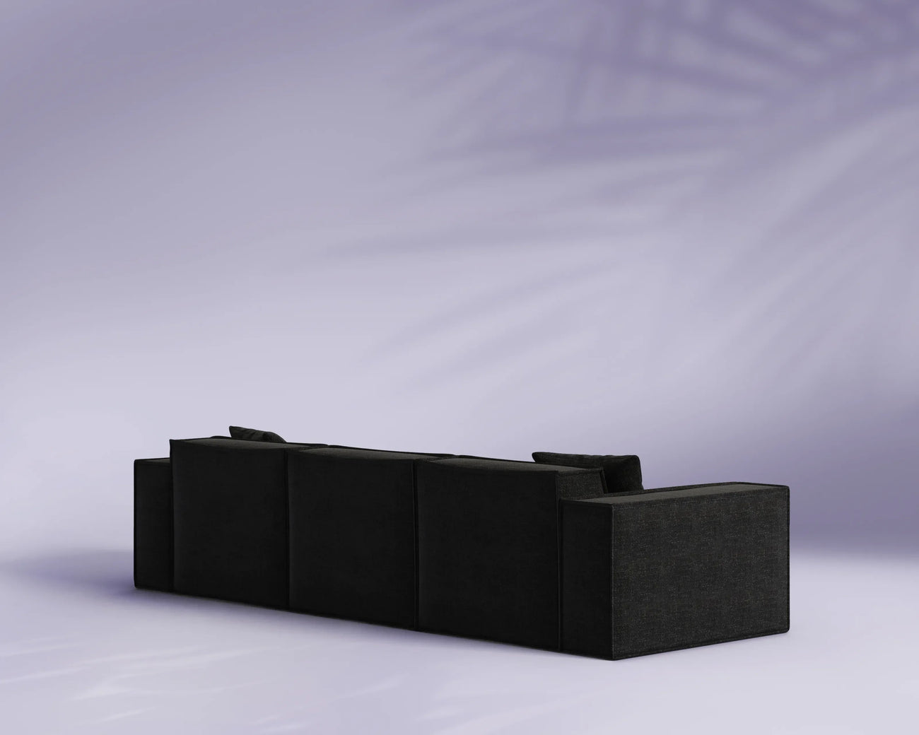 Black sectional sofa on a light gray background