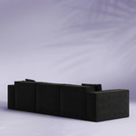 Black sectional sofa on a light gray background