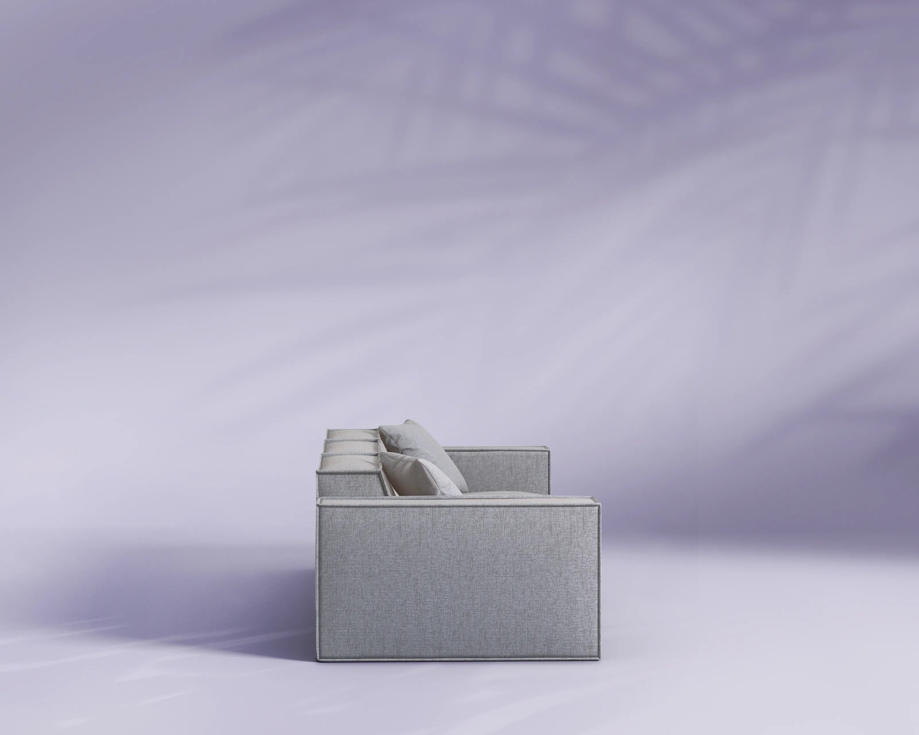 Gray fabric box with a white cylindrical object on a light purple background