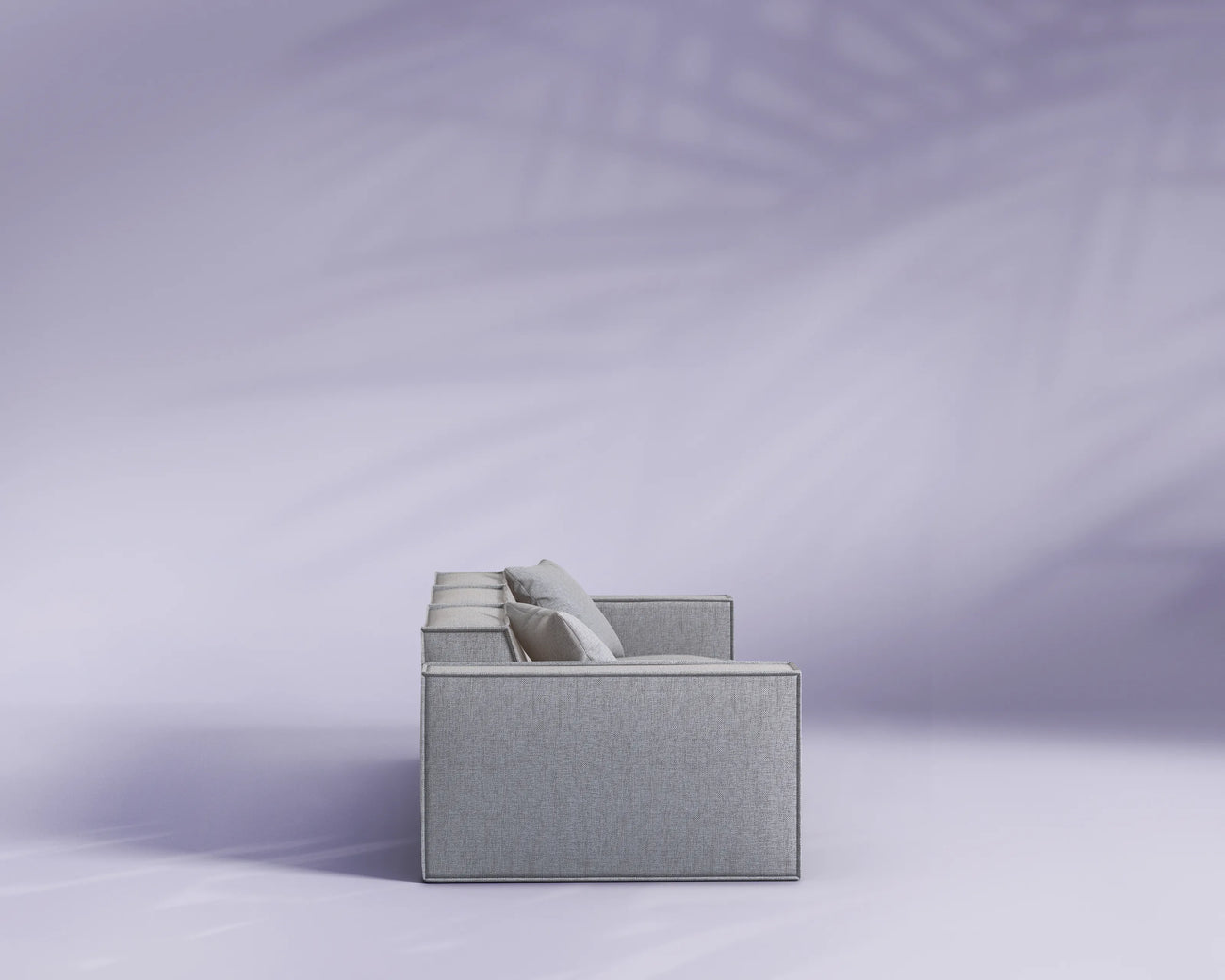 Gray fabric box with a white cylindrical object on a light purple background