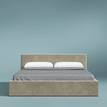 Beige bed with gray bedding and white pillows on a light blue background